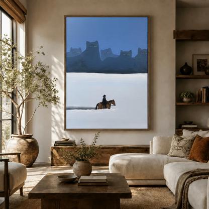 Surreal cowboy and giant black cat mountain canvas art displayed in a cozy living room above a wooden sideboard