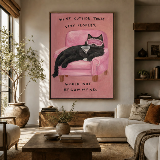 Funny black cat martini pink chair canvas displayed above a wooden sideboard in a warm neutral living room