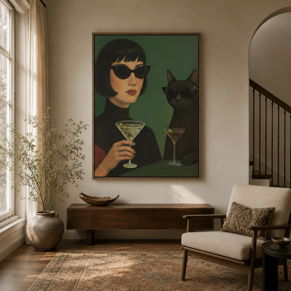 Framed vintage cat and woman cocktail wall art hanging in a modern entryway with staircase