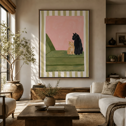 Orange tabby and black cat wall art in float frame styled in neutral living room with natural light
