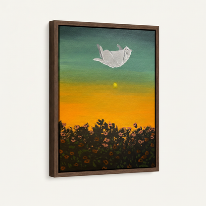 Framed float canvas of white cat drifting above golden sunflower field at sunset, angled side view